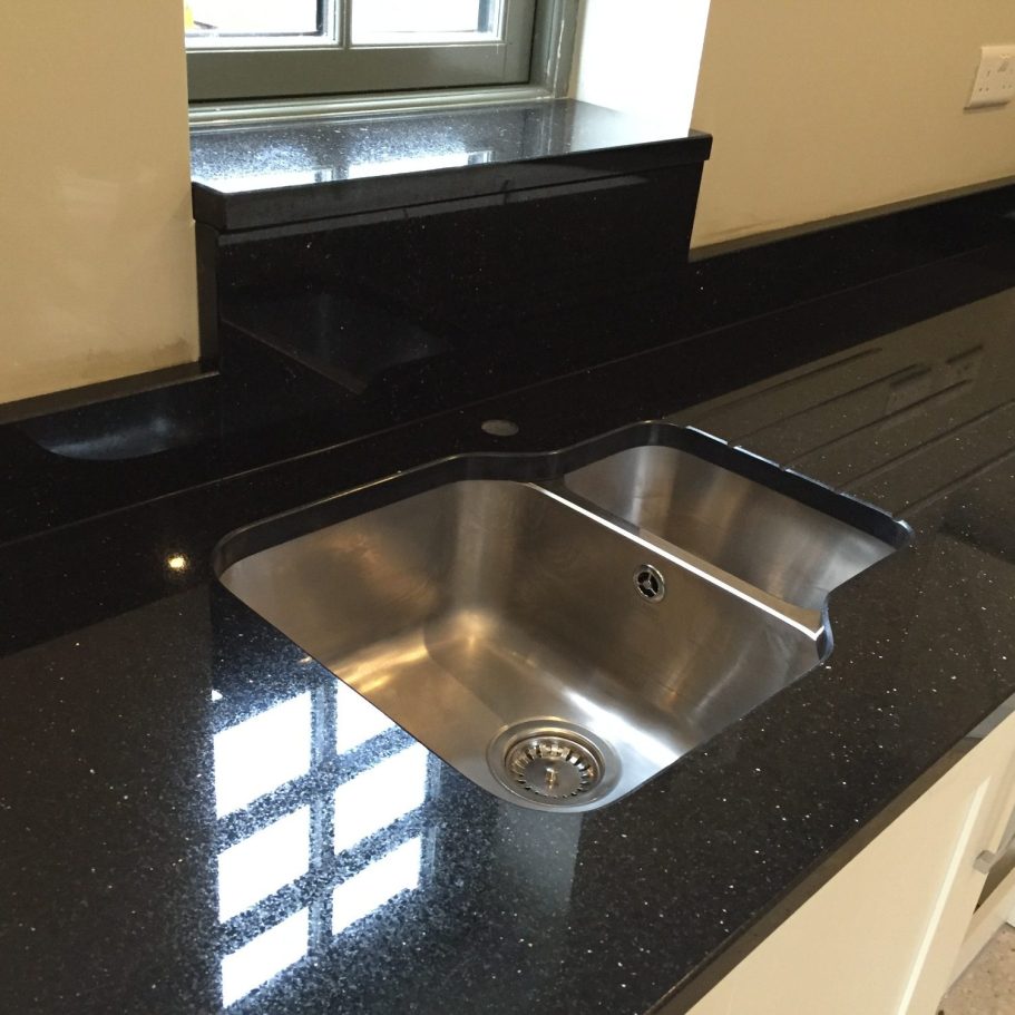 Star galaxy kitchen worktop run. Nero cosmos granite , had to rebuff inside of granite at the sink area . Chipped and scratched on the inside of the sink area.