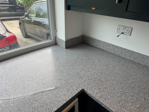 Before repair: cracked Corian in Leeds Grey Corian worktop in Leeds with a raised crack and uneven surface before repair