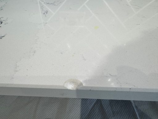 Before repair: chipped quartz edge in Penistone Large chip affecting the edge and surface of a white quartz worktop in Penistone
