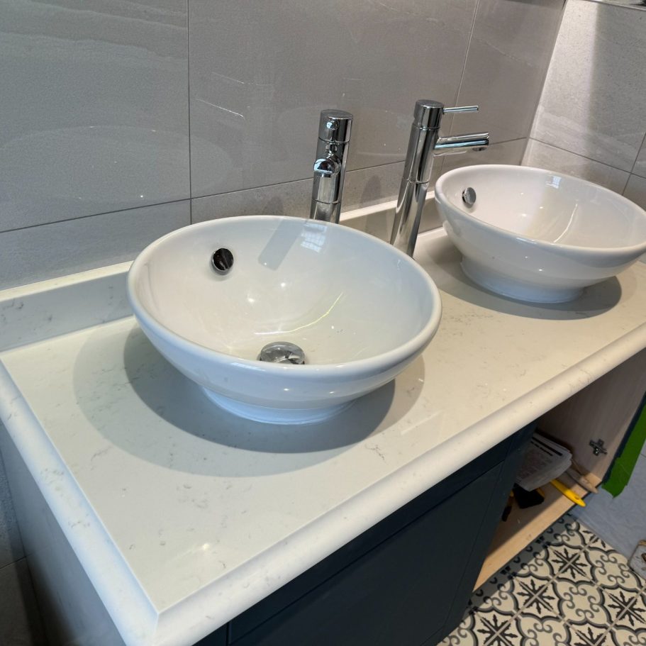 Carrera white vanity top with og edge detail Quartz vanity bathroom top fitted in highburton huddersfield. His and hers bathroom vanity top with a ogee edge detail.