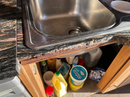 Before repair: broken granite sink section Granite worktop in Huddersfield with a broken front section missing beneath the sink